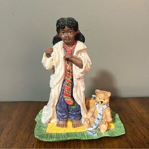 Martha Holcombe figurine of a young girl in a doctor's coat with a teddy bear.